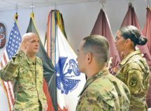 Brig. Gen. Ron Stephens, Regional Health Command Europe commanding general, delivers the oath of enlistment to Staff Sergeants Carlos and Jamie Castillo.