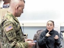 Ashley Bryles, USAG Rheinland-Pfalz emergency operations manager, answers questions for Command Sgt. Maj. Brett Waterhouse, USAG RP command sergeant major, in the garrison emergency operations center.