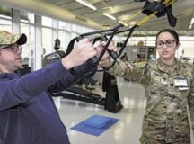 U.S. Army Capt. Jacqueline Tamayo, right, Landstuhl Regional Medical Center occupational therapy assistant chief, coaches U.S. Navy Petty Officer 2nd Class Even Parker, Armed Forces Network Europe photographer, through hand strength exercises at LRMC, March 3. LRMC has three occupational therapy resources to help recovering patients accomplish everyday tasks: the orthopedic clinic, the traumatic brain injury clinic and the Evolutions Program.