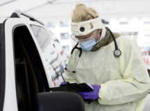 U.S. Air Force Staff Sgt. Maxime Copley, 86th Medical Group independent duty medical technician, writes down patient information in the Ramstein Medical Clinic’s coronavirus disease 2019 screening drive-thru at Ramstein Air Base, March 31. The 86th MDG transformed their main parking lot into a drive-thru to expedite testing and prevent the spread of COVID-19. Photo by Airman 1st Class Taylor D. Slater