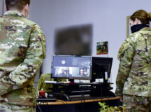U.S. Air Force Senior Airman Christopher Williams, left, 86th Munitions Squadron precision guided munitions crew chief, is recognized by wing and squadron leadership via teleconferencing at Ramstein Air Base, Germany, April 9, 2020. August and Rendon honored Williams with Airlifter of the Week while maintaining coronavirus disease 2019 physical distancing. The award was an example of how Team Ramstein innovates to continue the mission. (U.S. Air Force photo by Senior Airman Elizabeth Baker)