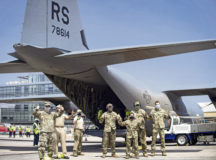 U.S. Air Force Airmen stand tall after a successful mission of delivering medical supplies provided by Navy Medical Research Unit Three-Ghana Detachment to Accra, Ghana, April 24. The delivery of approximately 4,000 pounds of medical supplies from across the world signals the international investment in the response to the COVID-19 global pandemic. Photo by Staff Sgt. Devin Nothstine