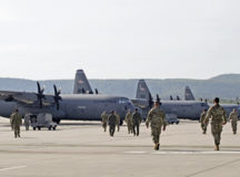 U.S. Airmen assigned to the 86th Operations Group, 86th Maintenance Group and 86th Medical Group walk toward a fleet of C-130J Super Hercules aircraft at Ramstein Air Base, April 24. Personnel from each group collaborated to test the operability of ion distribution units in C-130J cleaning procedures for disinfection after simulated medical patient transfer. If successful, the disinfection process would qualify the C-130J to be added to the list of aircraft that are aeromedical evacuation capable for coronavirus disease 2019. Photos by Airman 1st Class John R. Wright