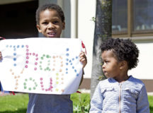 Aiden, a military dependent, holds up a sign thanking Kaiserslautern Military Community first responders during the Heroes through Housing event in on-base housing at Ramstein Air Base, May 7. Families were encouraged to make signs, cheer, wave and clap while adhering to physical distancing standards.
