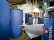William McCarthy, facility director for Landstuhl Regional Medical Center and Regional Health Command Europe, checks blueprints for recently-installed water treatment equipment at LRMC. McCarthy was recently recognized as the civilian of the year for 2019.