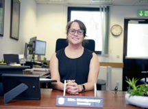 Jo Montgomery, 86th Mission Support Group commander's secretary, poses for a photo at her desk at Ramstein Air Base, July 28. As the daughter of parents belonging to the 82nd Airborne Division, Montgomery said she's proud to contribute to her family's rich history with the military.