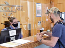 Jennifer Ankovic, 786th Force Support Squadron lead guest service representative, left, checks in a guest at the Ramstein Inn on Ramstein Air Base, Germany, Aug. 25, 2020. The 786th FSS Kaiserslautern Military Community lodging operation at Ramstein was awarded the 2020 Air Force Innkeeper Award for being the best large-category lodging operation in the Air Force. (U.S. Air Force photo by Airman 1st Class John R. Wright)