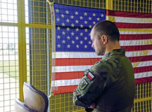 Polish army Lt. Jakub Sobolewski, Inspectorate for Armed Forces Support (Medical Division) physician and specialist), looks out of a window overlooking the flightline at Ramstein Air Base, Germany, July 27, 2021. The Polish military visited Ramstein Air Base to observe Negatively Pressurized Conex Lite, used to transport COVID-19 patients, training. (U.S. Air Force photo by Airman 1st Class Madelyn Keech)