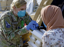 U.S. Space Force Capt. Justine Pescetello-Parr, 603rd Air Operations Center space weapons operator, helps distribute utensils to evacuees at Ramstein Air Base, Germany, Aug. 31, 2021. Volunteers work around the clock to support evacuees during their time at Ramstein. (U.S. Air Force photo by Airman Edgar Grimaldo)