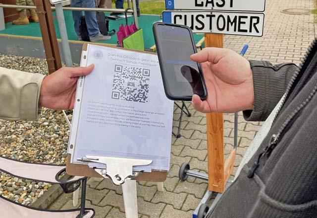A customer scans a QR code to be added to a virtual line at Sembach vehicle registration. The organization is releasing a new program for customers to check in to a virtual queue. This new process gives customers estimated wait times, a way to check if the organization is full for the day, and allow for patrons to avoid standing in line for hours.