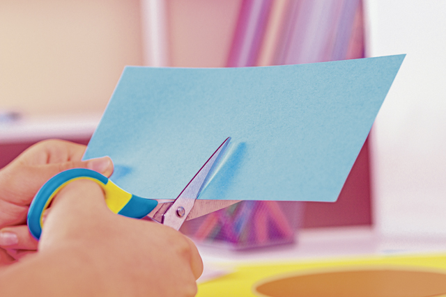 Kid,Hands,Cutting,Light,Blue,Colored,Paper,With,Scissors