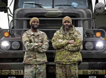 U.S. Army Cpl. Tremier Cook, 66th Transportation Company motor transportation operator, left, and Staff Sgt. Ray Brown, 66 TC motor transportation squad leader, right, assigned to Kleber Kaserne, Germany, await munitions cargo placement for a long-haul transport at Ramstein Air Base, Germany, Feb. 4, 2022. Airmen from the 86th Munitions Squadron safely place crates with munitions cargo on semi trucks for Cook and Brown to transport to another base.  (U.S. Air Force photo by Airman 1st Class Jared Lovett)