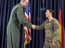 U.S. Space Force Tech. Sgt. Hollie Baire, non-commissioned officer in charge of the 86th Communications Squadron non-commissioned officer in charge of the Technical Control Facility receives a coin from U.S. Air Force Col. Denny Davies, 86th Airlift Wing Vice Commander at an all call at Ramstein Air Base, Germany, March 24 2022. Baire was awarded the title of Airlifter of the Week due to her part in facilitating the installation of $750,000 of new Defense Information Systems. (U.S. Air Force photo by Senior Airman Thomas Karol)