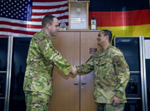 U.S. Air Force Tech. Sgt. Bryson Ott, 786th Civil Engineer Squadron non-commissioned officer in charge of aircraft rescue systems, receives his Airlifter of the Week coin from Col. Denny Davies, 86th Airlift Wing vice commander, at Ramstein Air Base, Germany, April 7, 2022. Ott was recognized for his leadership skills and being a subject matter expert in his career field. (U.S. Air Force photo by Airman 1st Class Jordan Lazaro)