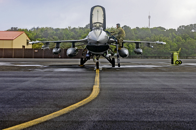U.S. Air Force Master Sgt. James Thammavongsa, 65th Air Base Group quality assurance superintendent, prepares an F-16 Fighting Falcon aircraft assigned to Shaw Air Force Base, South Carolina, for launch during a coronet mission through Lajes Field, Azores, Portugal, April 27, 2022. The Lajes team provides critical ground maintenance support to multiple aircraft, from bombers and fighters to tankers and cargo. (U.S. Air Force photo by Senior Airman John R. Wright)