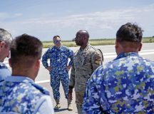 Service members from the U.S. Air Force and Romanian air force discuss the maintenance of the Barrier Arresting Kit (BAK-12) during a maintenance training at Fetesti Air Base, Romania, July 18, 2022. The training event was designed to allow the exchange of knowledge pertaining to the operation and maintenance of the respective arresting systems. (U.S. Air Force photo by Airman 1st Class Alexcia Givens)
