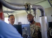 U.S. Air Force Staff Sgt. Dashawn Smith, 435th Contingency Response Support Squadron air advisor, collaborates with members of the Romanian air force to provide maintenance to a Barrier Arresting Kit at Fetesti Air Base, Romania, July 18, 2022. Smith explained to Romanian air force members the daily, monthly and quarterly procedures used to maintain the BAK-12. (U.S. Air Force photo by Airman 1st Class Alexcia Givens)