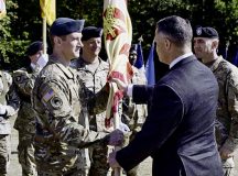 Mr. Tommy R. Mize, Installation Management Command-Europe director passes the unit colors to Col. Reid E. Furman, U.S. Army Garrison Rheinland-Pfalz commander during a change of command ceremony, July 22, 2022, at Kaiserslautern, Germany.  Furman assumed command of the unit from Lt. Col. Jeremy A. McHugh. (U.S. Army Photo by Elisabeth Paqué)