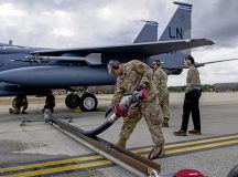 U.S. Air Force Airmen assigned to the 435th Contingency Response Squadron, Ramstein Air Base, Germany, conduct an F-15 hot-pit refueling training with the 48th Maintenance Group at Royal Air Force Lakenheath, England, July 27, 2022. The training aids in expanding the squadron’s Agile Combat Employment capabilities. (U.S. Air Force photo by Airman 1st Class Olivia Gibson)