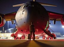 An Airman prepares to marshal a C-17 Globemaster III at Moody Air Force Base, Ga., July 18, 2021. The Airmen were preparing for a deployment to Southwest Asia in support of Operation Allies Refuge. 
 Photo by Staff Sgt. Devin Boyer