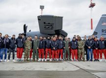 Football Club Kaiserslautern (1 FCK) players and Airmen pose for a photo beside a C-130J Super Hercules aircraft assigned to the 37th Airlift Squadron at Ramstein Air Base, March 23. The 1 FCK visit was the first time since the 1970’s that the team has visited the base and provided the players the opportunity to spend time with American fans stationed here. Photo by Airman 1st Class Jared Lovett