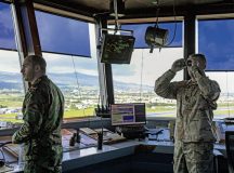 A member of the Portuguese Air Force, and Tech. Sgt. Stephen Greathouse, 65th Air Base Squadron tower chief controller, prepare for an incoming aircraft at Lajes Field, Portugal, Oct. 18, 2022. The joint operability between the POAF and the USAF ensures the air traffic control tower runs smoothly. (U.S. Air Force photo by Airman 1st Class Lauren Jacoby)