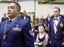 Senior noncommissioned officer inductees stand in recognition of their achievements at a ceremony at Ramstein Air Base, Germany, July 21, 2023. The ceremony served as a moment of pride and celebration for the inductees and their families, as well as  recognition of their increase in responsibilities as leaders. (U.S. Air Force photo by Airman 1st Class Kaitlyn Oiler)
