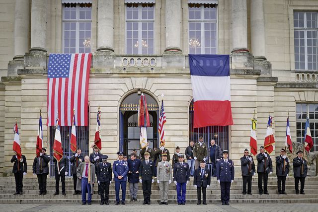 Representatives of the French and United States Militaries stand in front of the Hotel de Ville de Chalons-en-Champagne, the city hall of the town, concluding the Armistice Day 105th Anniversary Celebration in Chalons-en-Champagne, France on Nov. 11, 2023. The celebration encompassed both the 105th Anniversary of the Armistice signing and the 100th anniversary of the lighting of the Flame of Remembrance at the Tomb of the Unknown Soldier at the Arc de Triomphe in Paris, France. (U.S. Army photo by Spc. Samuel Signor)