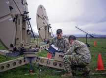 U.S. Air Force Airman 1st Class Ryan Smith, left, and Airman 1st Class Yekun Yang, right, 1st Combat Communications Squadron radio frequency transmissions system technicians, check cable connections on a satellite dish during exercise HEAVY RAIN 23, at Grostenquin, France, Nov. 16, 2023. HEAVY RAIN is a U.S. Air Forces in Europe-led command and control exercise that integrates communicators, operators and aggressors from joint forces, NATO allies and partners, testing and evaluating their communication and data-sharing capabilities in a rapidly changing operating environment. (U.S. Air Force photo by Senior Airman Jared Lovett)