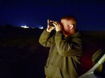 Lee Taylor, U.S. Department of Agriculture wildlife biologist assigned to the 406th Air Expeditionary Wing safety office, monitors the space around the airfield at Air Base 201, Niger, during a nighttime wildlife survey Jan. 17, 2024. The wildlife survey is part of the Bird/Wildlife Aircraft Strike Hazard program to monitor and deter animals that could be a threat to aircraft and the airfield environment. (U.S. Air Force photo by Tech. Sgt. Rose Gudex)