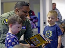 U.S. Air Force Brig. Gen. Otis C. Jones, 86th Airlift Wing commander, shows imagery from the book “Tuskegee Airmen” to children during story time at the Ramstein Library on Ramstein Air Base, Germany, Feb. 8, 2024. Jones spent quality reading time to bring awareness on the historical significance of the Tuskegee Airmen. (U.S. Air Force photo by Airman Dylan Myers)