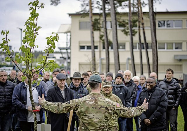U.S. Army Col. Reid Furman, U.S. Army Garrison Rheinland-Pfalz commander, center, speaks to garrison employees who gathered to both celebrate Earth Day and remember the late Lutz Andres, a former garrison employee, April 19, 2024, on U.S. Army Garrison Rheinland-Pfalz, Germany. Furman emphasized that his command treats environmental stewardship as an everyday responsibility of each Department of Defense member. (Defense Media Activity photo by Senior Airman Christian Conrad)