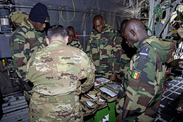 U.S. Air Force Staff Sgt. Dylan Cruse, 86th Aeromedical Evacuation Squadron aeromedical evacuation technician, shows members of the Senegal air force a trauma kit in a C-130H Hercules trainer aircraft at Ramstein Air Base, April 23. Representatives from the Senegal air force toured multiple workspaces across the 86th Maintenance Squadron to learn how each section operates and about various types of equipment. Photo by Airman 1st Class Trevor Calvert