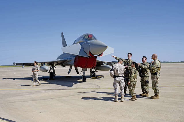 U.S. Air Force security forces defenders assigned to the 496th Air Base Squadron perform a combined patrol with a Spanish air force defender at Morón Air Base, Spain, April 16, 2024.  Defenders were tasked to patrol two Eurofighters and a B-1B Lancer assigned to Dyess Air Force Base, Texas, during an aircraft tour for base members and their families. (U.S. Air Force photo by Airman 1st Class Eve Daugherty)