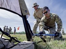 U.S. Air Force Master Sgt. James Supernault, left, 435th Contingency Response Squadron operations flight chief, and Staff Sgt. Justin Salvione, 435th CRS airborne contingency response air traffic controller, stake down a Tactical Operations Center tent during Swift Response 24 at Hungarian Defense Forces 101st Aviation Wing, Hungary, May 6, 2024. SR24 is a series of multinational interoperability exercises under DEFENDER 24 led by U.S. Air Forces in Europe – Air Forces Africa to advance Agile Combat Employment capabilities in the European theater. (U.S. Air Force photo by Senior Airman Jared Lovett)