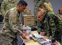 U.S. Army Staff Sgt. Mario Leonmiti, left, 512th Field Hospital emergency room platoon sergeant, demonstrates a wound packing method to Bulgarian medics at Ramstein Air Base, Germany, Sept. 16, 2024. Bulgarian medical specialists explained ways their forces were taught to improvise in battlefield scenarios if they lack the necessary resources. (U.S. Air Force photo by Airman 1st Class Dylan Myers)