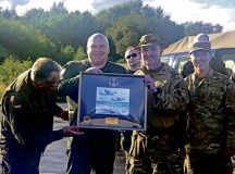 Polish leadership from the 8th Airlift Base and the 33rd Airlift Base, (left), stand with gifts received from U.S. Air Force Col. Leland Cowie, 435th Air Ground Operations Wing commander and Col. Damon Field, 435th Contingency Response Group commander, (right),  during exercise Agile Bison at Koszalin, Poland, Sept. 12, 2025. This exercise gave a realistic approach to strategic mobility and agile air operations, ensuring U.S. forces and NATO Allies remain ready to handle threats in any possible conflict. (U.S. Air Force photo Senior Airman Tabatha Chapman)