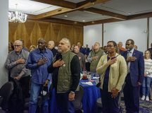 Retirees place their hands over their hearts for the national anthem during the 2025 Ramstein Retiree Appreciation Day at Ramstein Air Base, Germany, Sept. 30, 2025. This annual event provided a subject matter expert board the opportunity to thank retirees for their continued support in the community and to disseminate important resources available to them. (U.S. Air Force photo by Senior Airman Vaughn Weber)