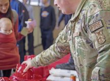 U.S. Air Force Senior Airman Mitchell Willis, 86th Civil Engineer Squadron firefighter, hands out plastic fire hats to children at the Fire Prevention Week open house event at Ramstein Air Base, Germany, Oct. 19, 2024. The open house was held at Fire Station 1 and included carnival-style games, fire station tours, prizes and fire safety events. (U.S. Air Force photo by Senior Airman Kaitlyn Oiler)
