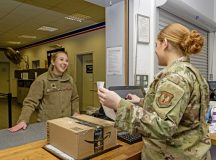Airman 1st Class Kaylee Moss, 786th Force Support Squadron postal clerk, receives outbound mail for U.S. Air Force Lt. Col. Connie Converse, 86th Healthcare Operations Squadron commander, at the Northside Post Office on Ramstein Air Base, Nov. 7. Moss ensures the correct forms are used when customers are mailing a package, as well as checking if there are specific issues such as an incorrect or illegible address or contents that are prohibited for shipment.