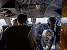 U.S. Air Force Tech. Sgt. Zachery Sewell, 76th Airlift Squadron flight engineer, points at another aircraft during a training flight at Ramstein Air Base, Germany, Nov. 21, 2025. The 76th AS conducts training flights to sustain global airlift readiness and ensure aircrews remain qualified to provide fast, executive-level transport for U.S., allied and partner leaders. (U.S. Air Force photo by Senior Airman Trevor Calvert)