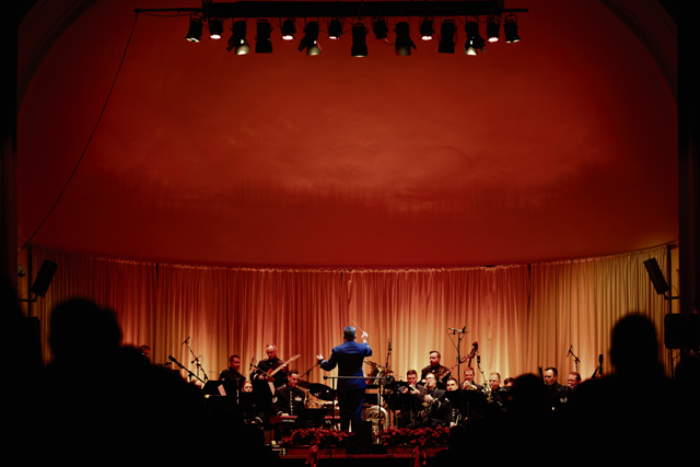 U.S. Air Force Lt. Col. Rafael Francisco Toro-Quiñones, U.S. Air Forces in Europe - Air Forces Africa band commander/conductor, leads the USAFE band during the Kaiserslautern Military Community Christmas concert at the Fruchthalle in Kaiserslautern, Germany, Dec. 12, 2025. These concerts offer a platform for cultural exchange and sharing of musical traditions between the U.S. Air Force musicians and European audiences. (U.S. Air Force photo by Senior Airman Edgar Grimaldo)
