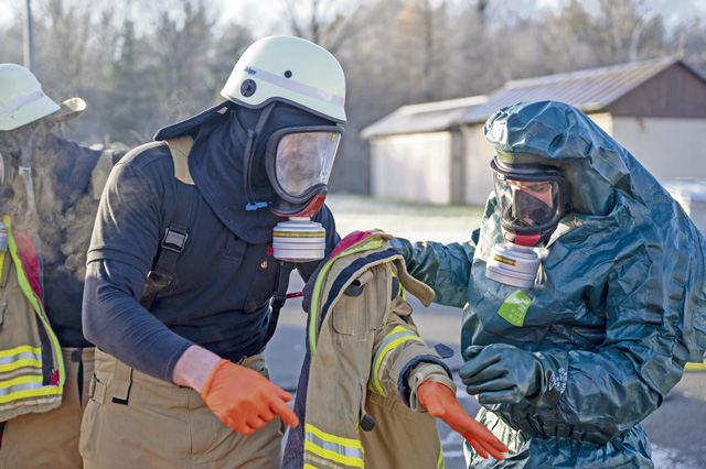 Airmen assigned to the 86th Civil Engineer Squadron begin the decontamination process during an ammonia leak exercise at Ramstein Air Base, Germany, Nov. 22, 2025. The exercise cultivated cooperation between German and American firefighters and increased knowledge of the equipment utilized by both, furthering their ability to support the Kaiserslautern military community. (U.S. Air Force photo by Senior Airman Vaughn Weber)