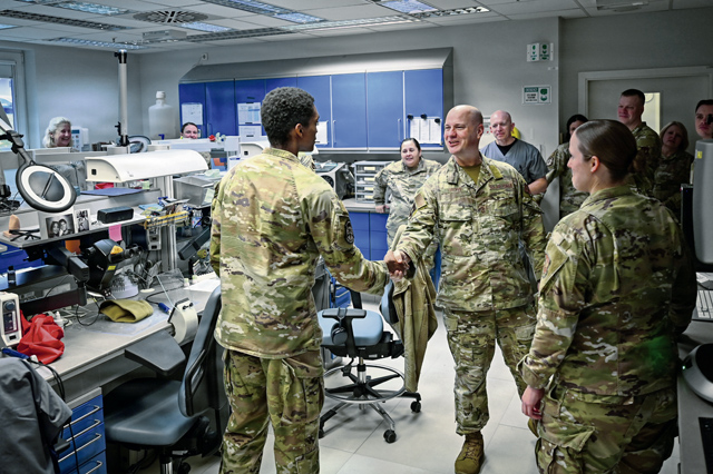 U.S. Air Force Chief Master Sgt. Jason Trickey, Third Air Force command chief, speaks with Airman 1st Class Quentin Butler, 86th Dental Squadron lab technician, during an immersion tour at Ramstein Air Base, Germany, Dec. 11, 2025. The visit allowed Third Air Force leadership to learn about the 86th Medical Group’s dental services and how they support the health, deployability and mission execution of Airmen across Ramstein. (U.S. Air Force photo by Airman 1st Class Rebecca Harima)