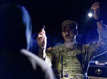 U.S. Army Staff Sgt. Victor Garza, a military police officer assigned to the 92nd Military Police Company, 709th Military Police Battalion, 18th Military Police Brigade, conducts a Horizontal Gaze Nystagmus test on a suspected impaired driver during a traffic stop at Rhine Ordnance Barracks, Germany, Jan. 30, 2026. The standardized field sobriety test assists military police in identifying potential impairment and ensuring roadway safety on the installation. (U.S. Army photo by Sgt. 1st Class Tanisha Karn)
