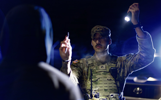 U.S. Army Staff Sgt. Victor Garza, a military police officer assigned to the 92nd Military Police Company, 709th Military Police Battalion, 18th Military Police Brigade, conducts a Horizontal Gaze Nystagmus test on a suspected impaired driver during a traffic stop at Rhine Ordnance Barracks, Germany, Jan. 30, 2026. The standardized field sobriety test assists military police in identifying potential impairment and ensuring roadway safety on the installation. (U.S. Army photo by Sgt. 1st Class Tanisha Karn)