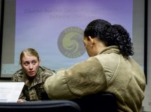 U.S. Air Force 2nd Lt. Allyson Peterson, 86th Operational Medical Readiness Squadron bioenvironmental flight officer in charge, discusses hypothetical decontamination procedures with Airman 1st Class Ceara Williams, 86th OMRS bioenvironmental flight technician, during exercise Radiant Falcon at Ramstein Air Base, Germany, Feb. 12, 2026. Airmen from various squadrons participated in the extensive training exercise to acquire and hone proficiency in radiological contamination detection and decontamination safety techniques. (U.S. Air Force Photo by Senior Airman Renan Arredondo)