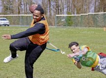 U.S. Army Spc. Adahnte Margrum, a petroleum supply specialist assigned to Headquarters and Headquarters Detachment, 709th Military Police Battalion, 18th Military Police Brigade, runs with the football as Spc. Michael Cooper, a combat medic assigned to the 554th Military Police Company, pursues him during a flag football game as part of the 709th Military Police Battalion Commander’s Cup at U.S. Army Garrison Hohenfels, Germany, April 9, 2026.