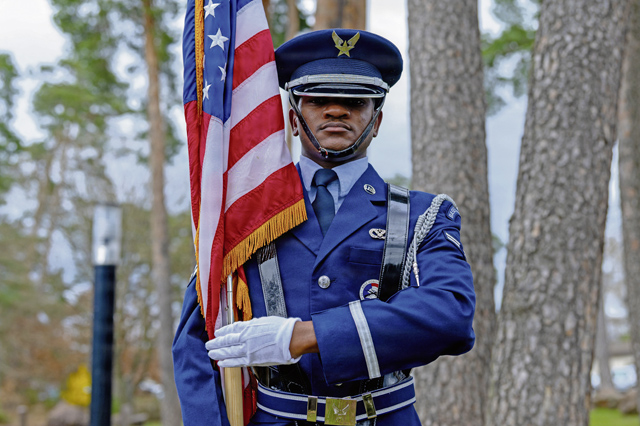 U.S. Air Force Airman 1st Class Maleik Findley, 786th Civil Engineer Squadron power production technician, stands at port arms after a memorial service on Ramstein Air Base, Germany, March 17, 2026. The base honor guard serves as a visible representation of the military’s values, discipline and tradition. (U.S. Air Force photo by Senior Airman Jason Jones Jr.)