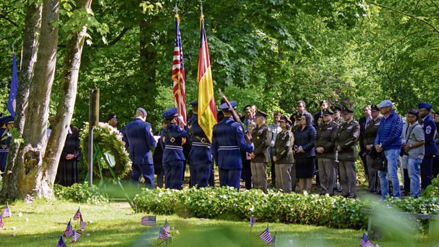 U.S. and German Kaiserslautern Military Community members bow their heads in silence during the Kindergraves Memorial Ceremony in Kaiserslautern, Germany, May 16, 2026. The Kaiserslautern Kindergraves Memorial Foundation, which is co-chaired by the German-American Club Kaiserslautern and the Ramstein Area Chiefs' Group, was established in 1986 to maintain the memorial site, organize remembrance ceremonies and address family inquiries. (U.S. Air Force photo by Staff Sgt. Sabrina Fuller-Judd)